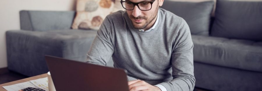A man working on his laptop and searching for HR consultancy in Dubai